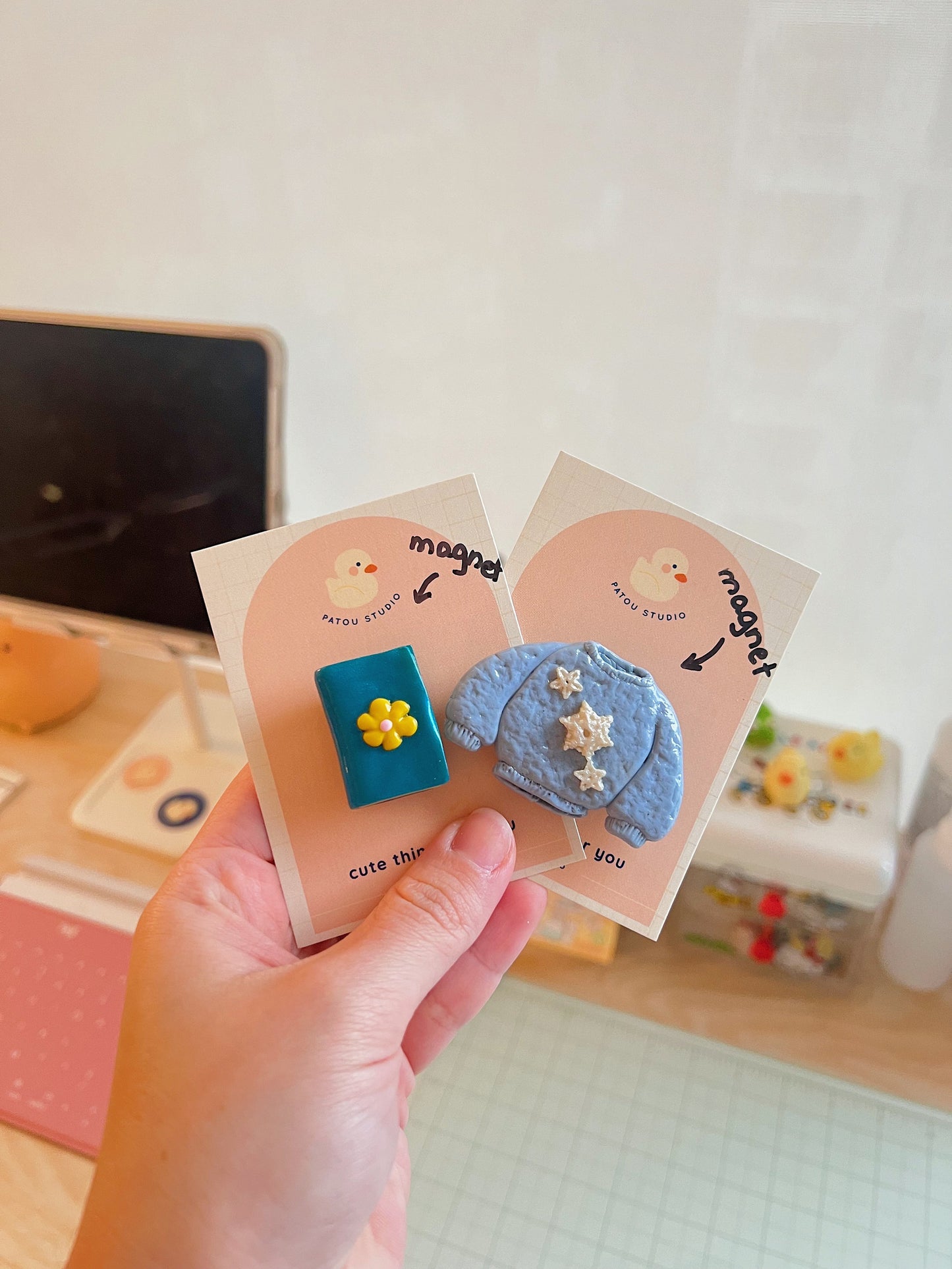 miniature book or sweater fridge magnets